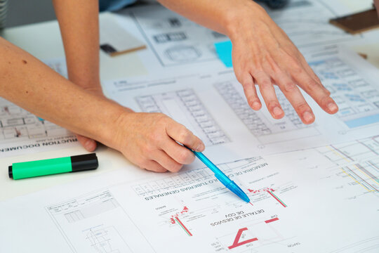 Cropped image of architects hands pointing on paper work