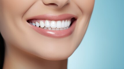 Obraz premium Beautiful woman's smile with healthy white, straight teeth close-up on light-blue background with space for text
