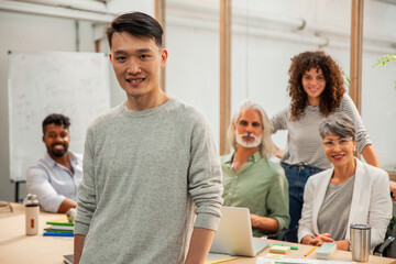 Graphic designer standing in office while looking at the camera