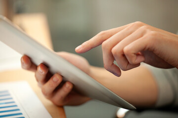 Close-up of unrecognizable person hands using digital tablet
