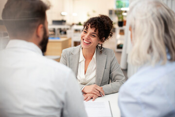 Cheerful female bank worker having a meeting with two clients