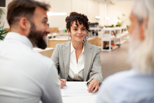 Female bank worker having a meeting with two clients