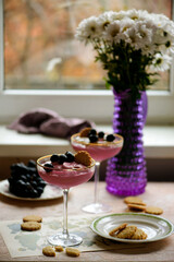 Wine mousse with grapes and cookies in a glass bowl