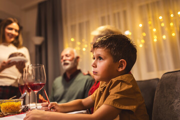 Portrait of grandchild on Christmas Eve with his family.