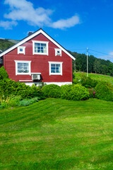 Vertical view of Scandinavian style house on green hill © QKon Studio