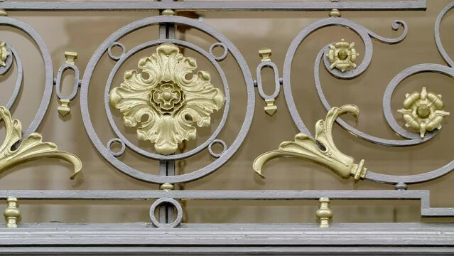 Regal iron fence detail, golden bloom centerpiece.