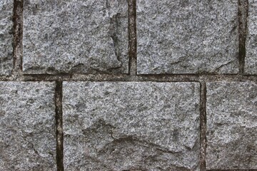 The old wall is made of granite stones . Macro. Canada.