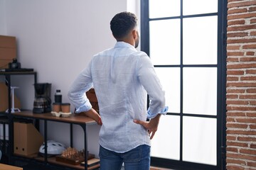 Young arab man business worker looking throw the window at office