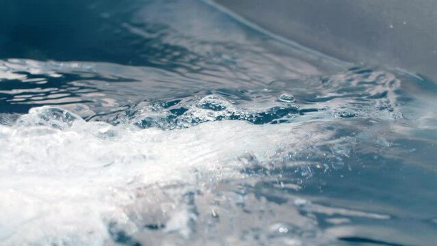 The serene movement of water in a pool water jet in hot tub