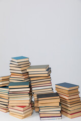 Many stacks of educational books to study in the university library on a background