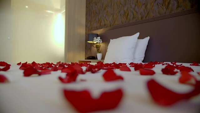 Elegant bed adorned with scattered rose petals.