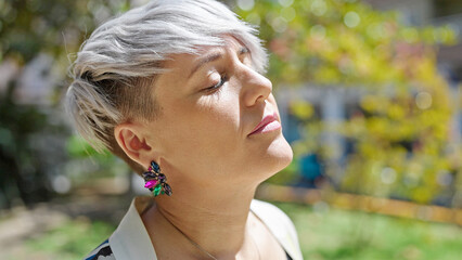 Young woman breathing with closed eyes at park