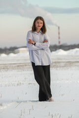 Portrait of a young beautiful girl in a winter forest.