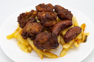 Japanese Karaage Fried Chicken with Fries and Sausage on a White Plate