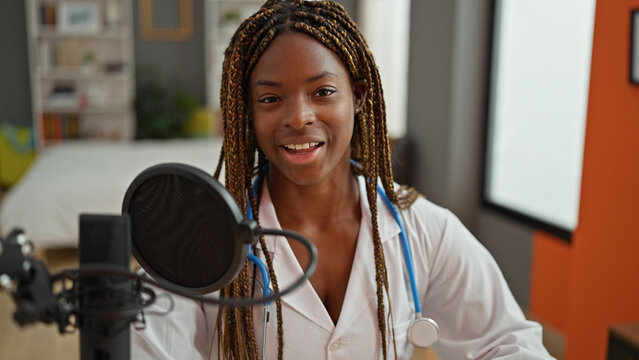 African american woman doctor having interview at radio studio