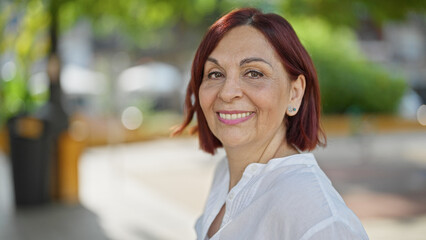 Middle age woman smiling confident standing at park