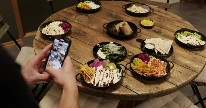 taking a picture of food on table