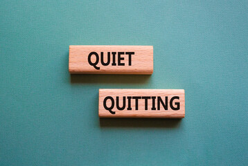 Quiet quitting symbol. Concept word Quiet quitting on wooden blocks. Beautiful grey green background. Business and Quiet quitting concept. Copy space.