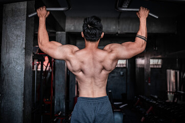 Fototapeta na wymiar Portrait of asian man big muscle at the gym,Thailand people,Workout for good healthy,Body weight training,Fitness at the gym concept,Asia men exercise chest muscle workout