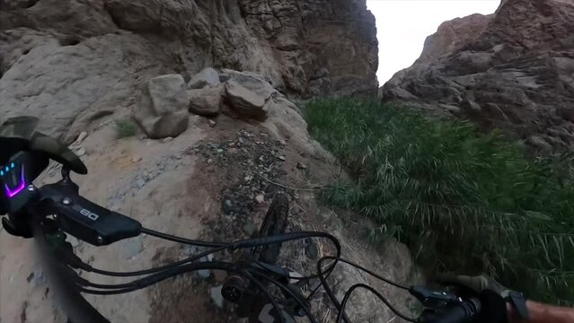 Man riding mountain bicycle through rock formations