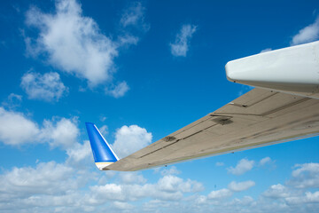 Detail of passenger aircraft wingtip against blue sky