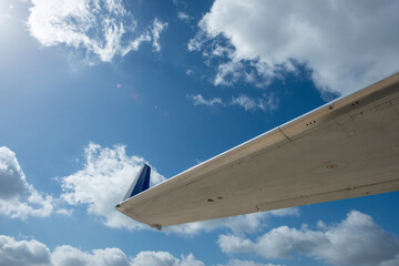 Detail of passenger aircraft wingtip against blue sky