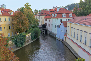 Fototapeta na wymiar Small district of Venice and the Certovka river in Prague, Czech Republic. Part of the Vltava River and Kampa Island in Mala Strana. River bed in the city. Streets of the old city landscape.