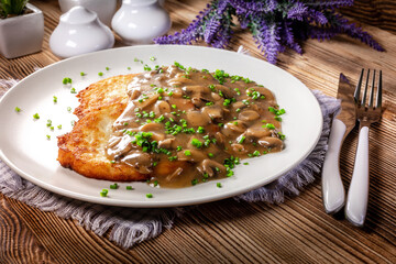 Crispy potato pancakes with mushroom sauce