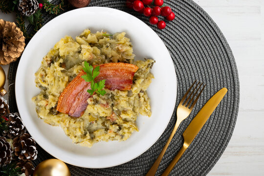 Trinxat de la Cerda&ntilde;a. Typical recipe from the north of Catalonia cooked with white cabbage, potato and bacon. Christmas food served on a table decorated with Christmas motifs.