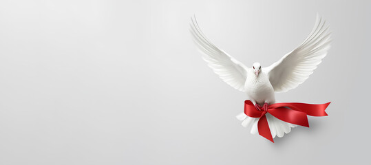 Obraz premium A pigeon with a red ribbon on a white background, a banner.