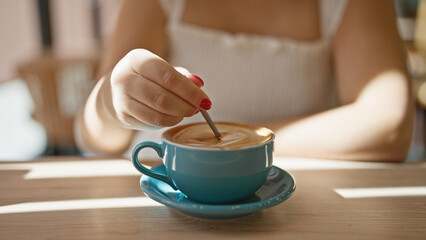 Cafe bliss, young woman enjoys leisurely coffee break, reveling in the sunny interior of a...