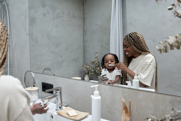 caring mom teaching her kid to brush teeth, close up photo. daily routine, motherhood, childhood,...