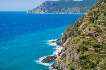 Fototapeta na wymiar Blue sea and cliff mountain with trail 