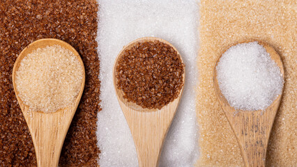 Various types of sugar, wholemeal, white and liquorice flavoured - obrazy, fototapety, plakaty
