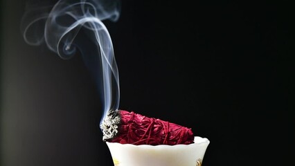 Slow motion smoke burning sage black background