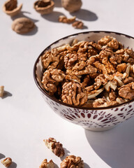 walnut in a ceramic plate, light background, minimalism, no people, close-up