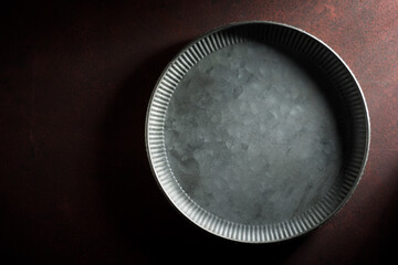 Empty metal dish on a kitchen table