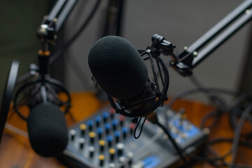 Podcasting studio copy space background image, close up of microphone and sound board, selective...