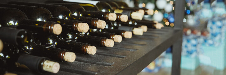 Bottles of wine shot with limited depth of field. wine cabinet in the interior. alcohol storage in...