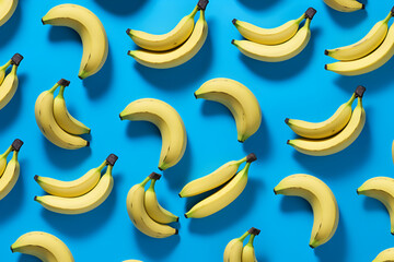 Seamless backdrop of colorful yellow bananas composed on blue surface in glowing light. Generated AI