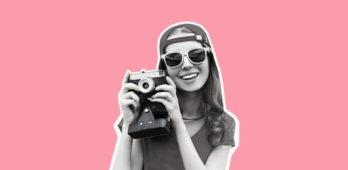 Portrait of happy cheerful smiling young woman photographer taking picture on film camera wearing...