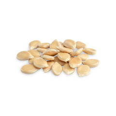 Heap of dried raw unshelled whole pumpkin seeds or pepita flat and asymmetrically oval isolated on...