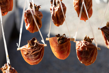 Dried Persimmons Get Sweeter, persimmons hanging to dry