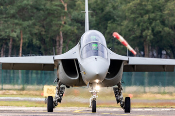 Modern light attack jet taxiing at an air base