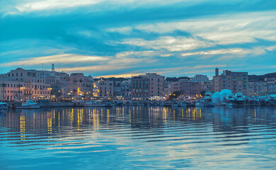 Dusk horizon over Anzio marina, reflected on the Mediterranean Sea