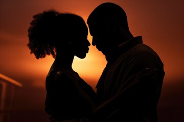 A captivating silhouette of a man and a woman standing together. Perfect for conveying love, partnership, and togetherness. Ideal for various projects and themes.