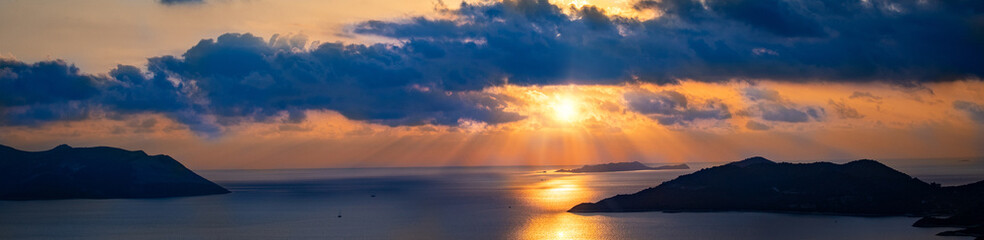 Fototapeta premium Sunset view in the mediterranean sea between Greece and Turkey. Left side is Megisti island and right side is Kaş Antalya. 