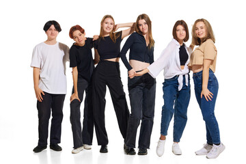 Fototapeta na wymiar Group of diverse young attractive girls, teenagers in casual outfit stands in line against white studio background. Concept of beauty, youth, emotions, fashion, style, modelling. Copy space for ad.