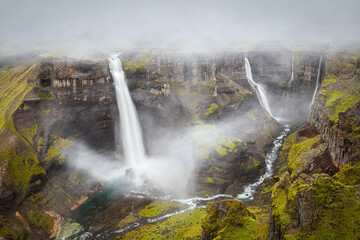 Landscape with a series of waterfalls (Haifoss) in a deep and narrow canyon in south Iceland