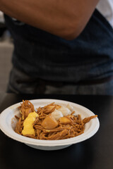 Noodle dish with langotinos with different types of sauces with a blurred background